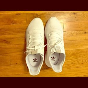 All white Adidas Tubular Shadow shoes